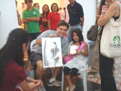 Graphic artist & ATD friend Robert Alejandro drawing on-the-spot portraitures.
